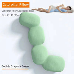 A light green, segmented memory foam body pillow shaped like a caterpillar.