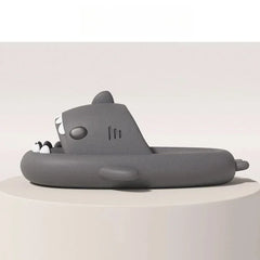A grey shark-shaped slide sandal with a wide strap and a platform sole.