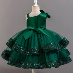 A sleeveless emerald green ball gown dress with a sequined tiered skirt and a large back bow.