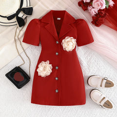A red short-sleeved blazer dress for girls featuring two large 3D cream-colored flower appliques.