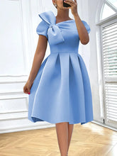 A sky blue knee-length skater dress featuring an asymmetrical neckline and a large shoulder bow.