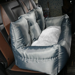 A grey, padded pet car seat with a plush white interior installed on a vehicle backseat.