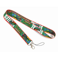 A green Teenage Mutant Ninja Turtles lanyard featuring Leonardo and a metal lobster clasp.