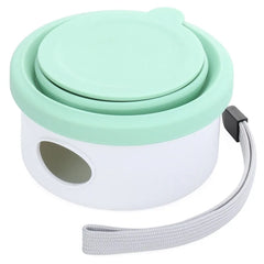 A portable green and white pet travel container with a wrist strap and a side opening.