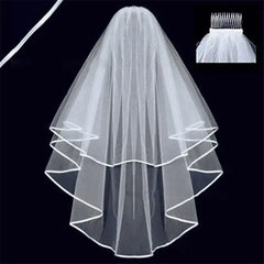 A two-layer white bridal veil with a ribbon edge and an attached hair comb.