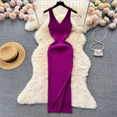 A magenta sleeveless knitted bodycon dress with a v-neckline and a side slit.