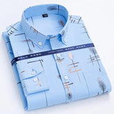 A light blue long-sleeve men's shirt with a gold-plated plaid print and a square collar.