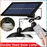 A double-head solar pendant light with a remote control and a solar panel.
