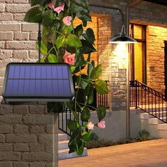 A solar-powered outdoor pendant light with a black lamp shade mounted on a brick wall.