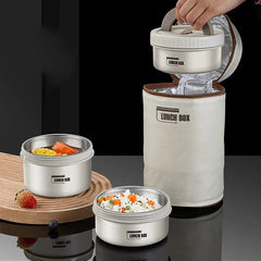 A stackable stainless steel bento lunch box set with an insulated carrying bag.