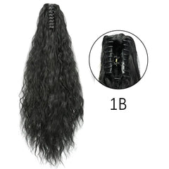 A long, wavy black synthetic ponytail hair extension with a claw clip attachment.