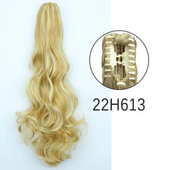 A long wavy blonde ponytail hair extension with a claw clip attachment.