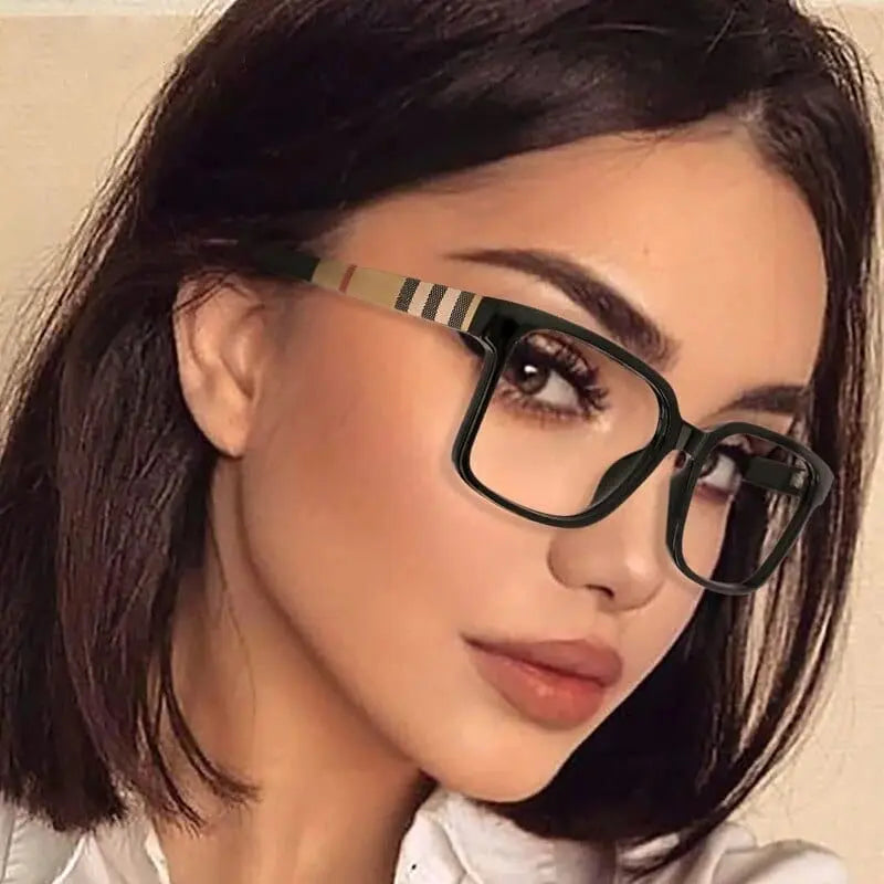 Woman with straight, dark brown hair and clear skin wears TR90 Retro Square Anti Blue Light Optical Glasses Frames featuring striped arms, dressed in a white collared shirt and looking slightly to the side.