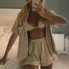 A person with long blonde hair takes a mirror selfie in a bedroom with light walls, wearing thick coral fleece warm loose-size pyjamas for women, styled with loafers for outdoors.