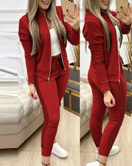 A woman wears a red two-piece tracksuit featuring a zippered stand-collar jacket and matching leggings.