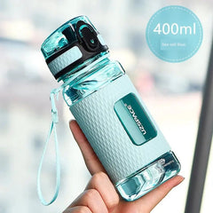 A sea salt blue Uzspace Tritan sports water bottle with a textured grip and a locking lid.