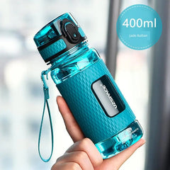 A teal 400ml UZSPACE sports water bottle with a textured grip and a locking lid held in a hand.