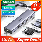 A silver UGREEN USB-C hub with four USB 3.0 ports and a metallic finish.