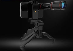 The Ultra Crystal HD 32x Zoom Telescope Mobile Phone Camera Lens Set is shown attached to a smartphone on a compact tripod, set against a dark background.