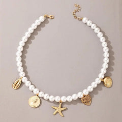 The Vintage Style Simple 6MM Pearl Chain Choker Necklace for women features five gold charms—a cowrie shell, a coin with a face, a starfish, a textured heart, and a scallop shell—arranged on simulated pearls.