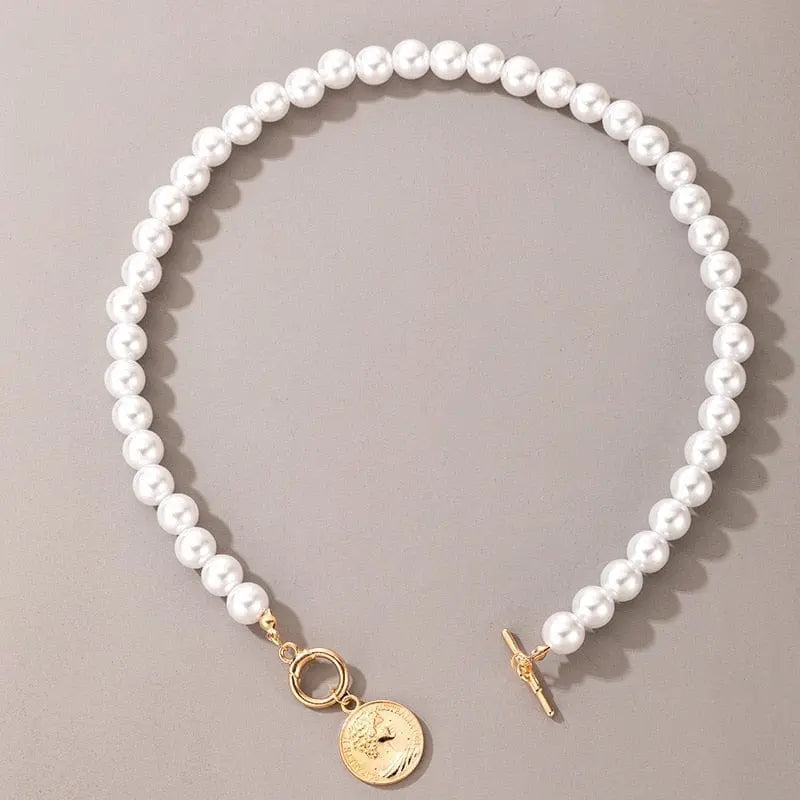 The Vintage Style Simple 6MM Pearl Chain Choker Necklace features simulated pearls, a gold toggle clasp, and a round shell pendant, displayed on a neutral gray background. Perfect for weddings or everyday fashion.