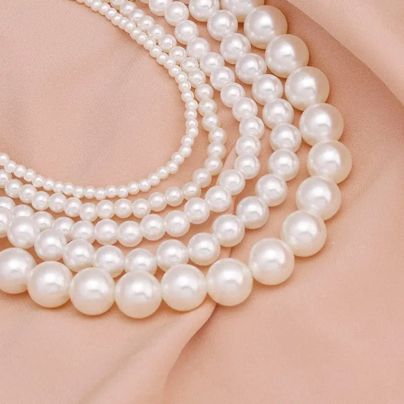The Vintage Style Simple 6MM Pearl Chain Choker Necklace, featuring a love shell pendant, is elegantly displayed on soft peach fabric—adding sophisticated charm to women's wedding and fashion jewelry collections.