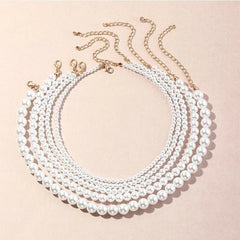 Five Vintage Style Simple 6MM Pearl Chain Choker Necklaces are arranged in concentric circles on a beige background. Each women's fashion necklace features pearls and a gold chain, perfect for weddings or as a love shell pendant accessory.