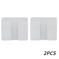 Two white wall-mounted mobile phone holders made of plastic.