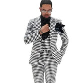A man wears a slim-fit, three-piece houndstooth suit with a black shirt and pocket square.