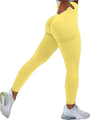 A woman wears high-waisted, seamless yellow workout leggings with a booty-lifting design.
