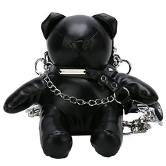 A black faux leather teddy bear shaped crossbody bag with a silver chain strap and collar.