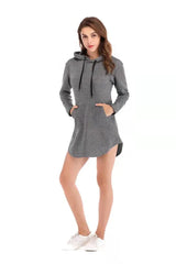 Woman in gray Showlu cotton sports hoodie dress with black drawstrings and front pocket, styled with white sneakers, white background.