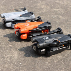 Three compact Z908 Pro Drone Professional 4K HD Camera Mini4 quadcopters in gray, orange, and black are lined up on concrete, angled alike. Each features a visible 4K HD camera and three-sided obstacle avoidance.