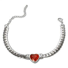 A silver-toned chain bracelet featuring a central red heart-shaped gemstone charm.