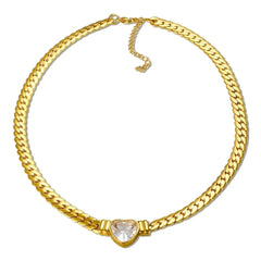 A gold-plated stainless steel chain necklace featuring a central heart-shaped crystal pendant.