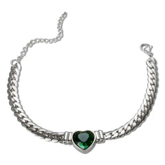 A silver-toned chain bracelet featuring a central green heart-shaped gemstone pendant.