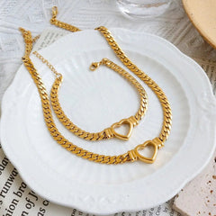 A gold-plated stainless steel jewelry set featuring a matching chain necklace and bracelet.