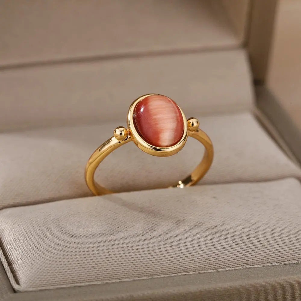 The Zircon Engagement Wedding Ring for women features a gold color stainless steel band with a polished pink cubic zirconia, presented on a beige ring holder in a jewelry box—an elegant 2023 birthday or wedding gift with free shipping.