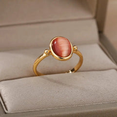 The Zircon Engagement Wedding Ring for women features a gold color stainless steel band with a polished pink cubic zirconia, presented on a beige ring holder in a jewelry box—an elegant 2023 birthday or wedding gift with free shipping.