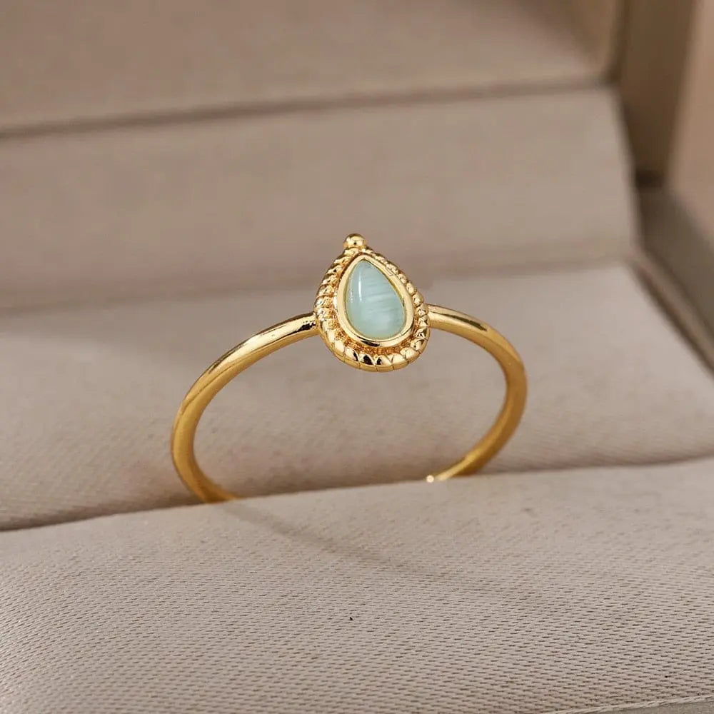 The Zircon Engagement Wedding Ring for Women features a gold color stainless steel band with a teardrop-shaped pale blue cubic zirconia—an elegant 2023 jewelry piece, perfect as a birthday gift or stylish wedding ring. Free shipping available.
