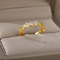 The Zircon Engagement Wedding Ring for women features gold-colored stainless steel with star-shaped cubic zirconia settings, beautifully presented in a beige jewelry box. Perfect as a 2023 finger jewelry birthday gift with free shipping.