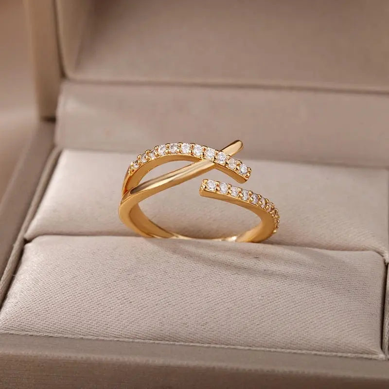 The Zircon Engagement Wedding Ring for Women features a gold color, crisscross design with clear cubic zirconia. Made of stainless steel, it comes in a beige jewelry box—an elegant 2023 gift for birthdays or weddings with free shipping.
