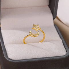 A gold color stainless steel ring featuring a crescent moon and star with cubic zirconia, presented in a gray box. Ideal as a Zircon Engagement or Wedding Ring for Women. 2023 Finger Jewelry, Birthday Gift, Free Shipping.