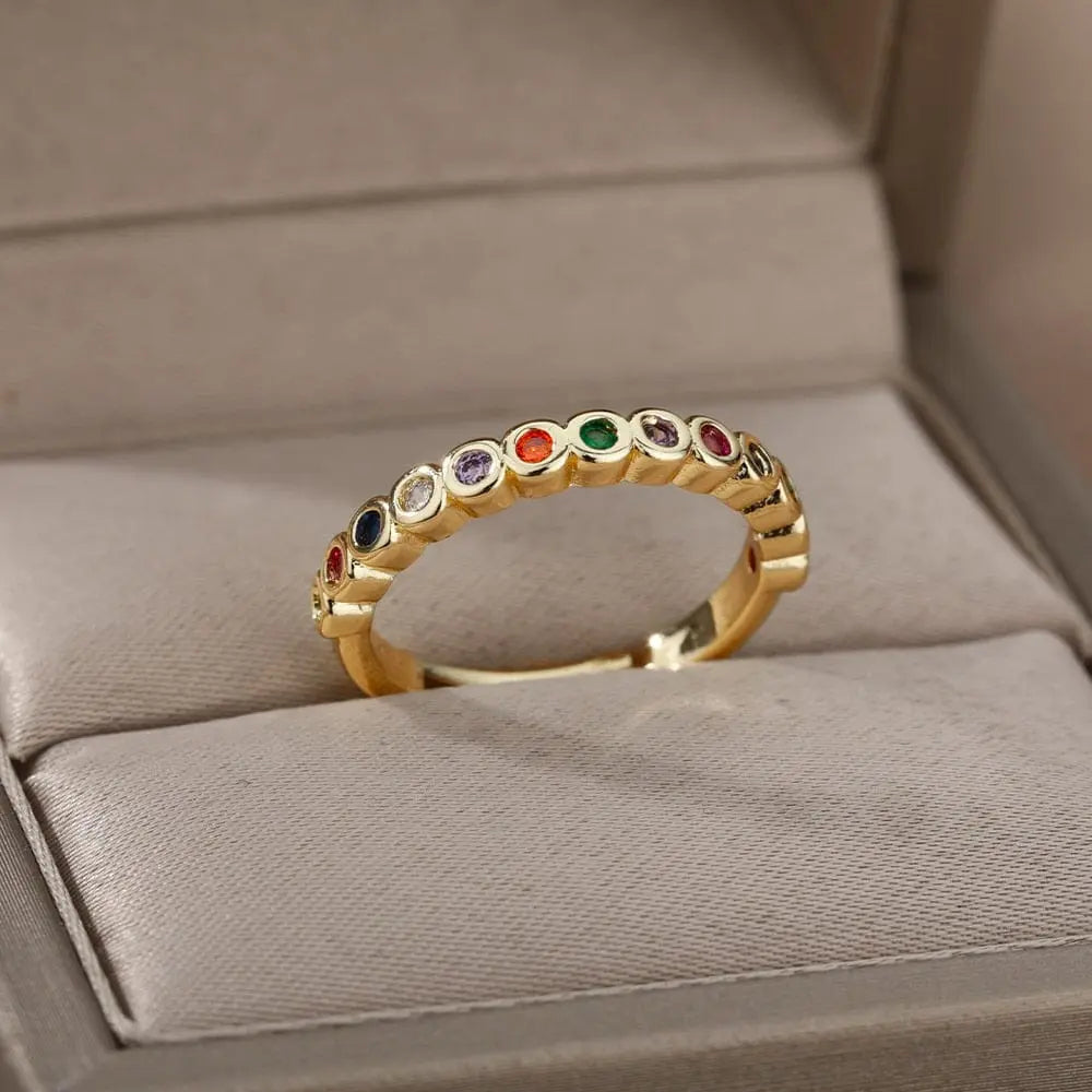 The Zircon Engagement Wedding Rings for Women feature a gold color stainless steel band set with sparkling zircon stones, presented in a soft beige jewelry box—perfect for weddings, engagements, or as a birthday gift. Free shipping included.