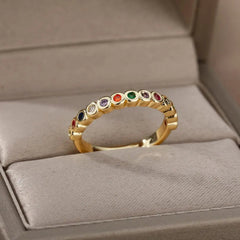 The Zircon Engagement Wedding Rings for Women feature a gold color stainless steel band set with sparkling zircon stones, presented in a soft beige jewelry box—perfect for weddings, engagements, or as a birthday gift. Free shipping included.