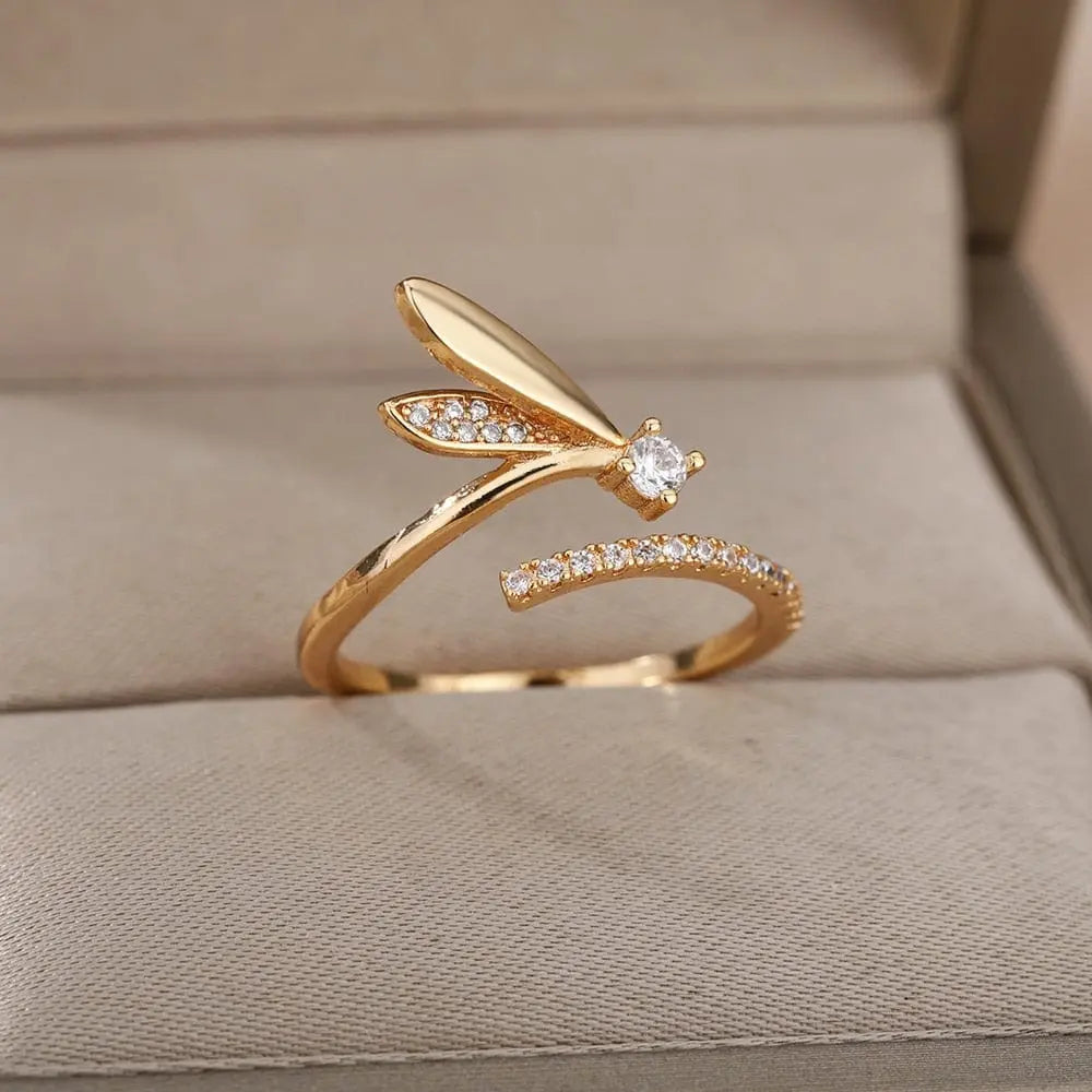 Zircon Engagement Wedding Ring for Women in gold color stainless steel, featuring sparkling stones and a central zircon, perfect as finger jewelry or a birthday gift. Ships free and displayed on a beige cushioned jewelry box.