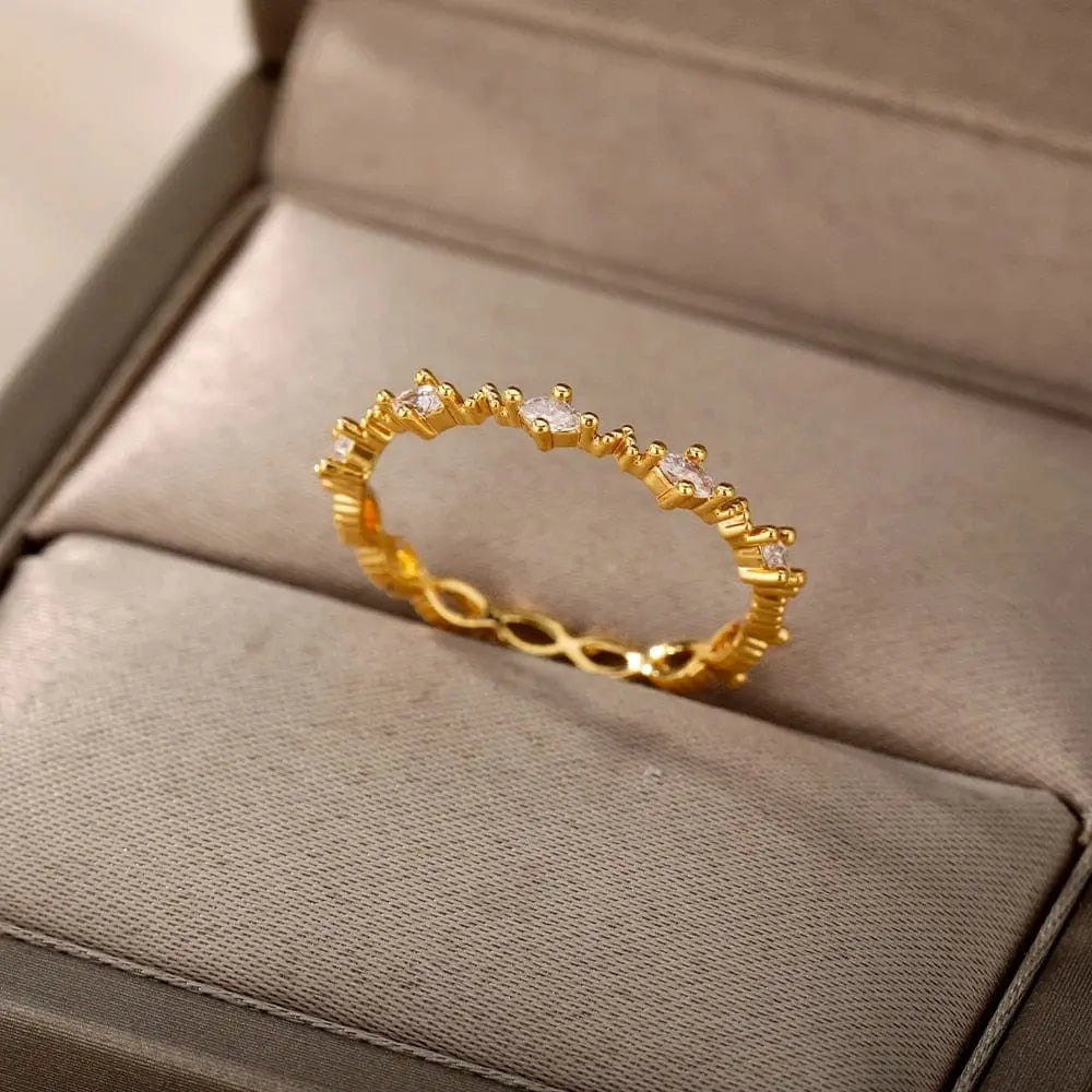 The Zircon Engagement Wedding Rings for Women feature gold color stainless steel with sparkling stones, making them a stylish 2023 finger jewelry gift. Comes in a beige velvet-like box. Free shipping included—perfect for birthdays or special occasions.