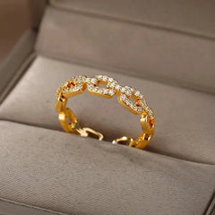 The Zircon Engagement Wedding Ring for women features a gold color chain-link design with sparkling cubic zirconia, crafted from stainless steel. Presented on a beige jewelry box, it's a perfect 2023 gift with free shipping.