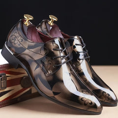 A pair of men's pointed-toe faux leather oxford dress shoes featuring a glossy floral pattern.