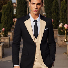 A man wears a black suit jacket with beige lapels, a matching beige vest, and beige trousers.